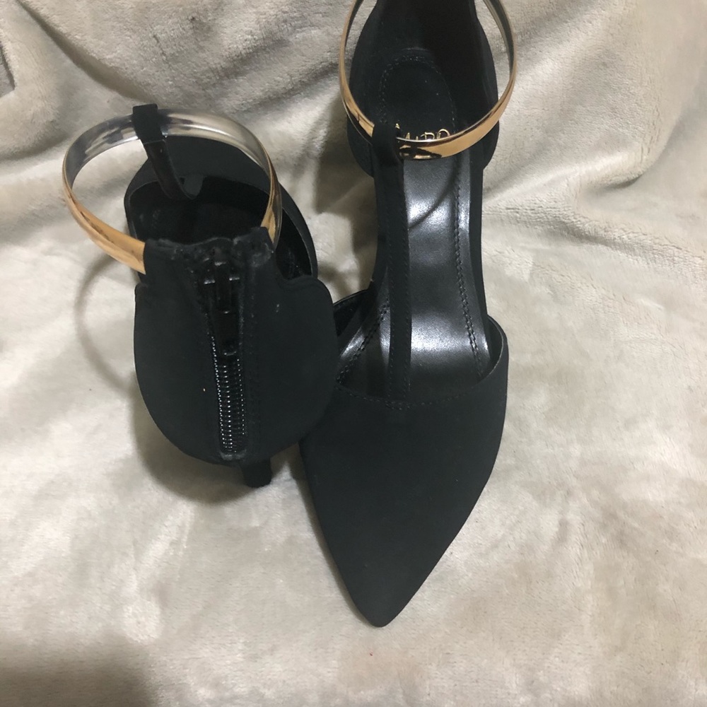 Black pumps with gold embellishments